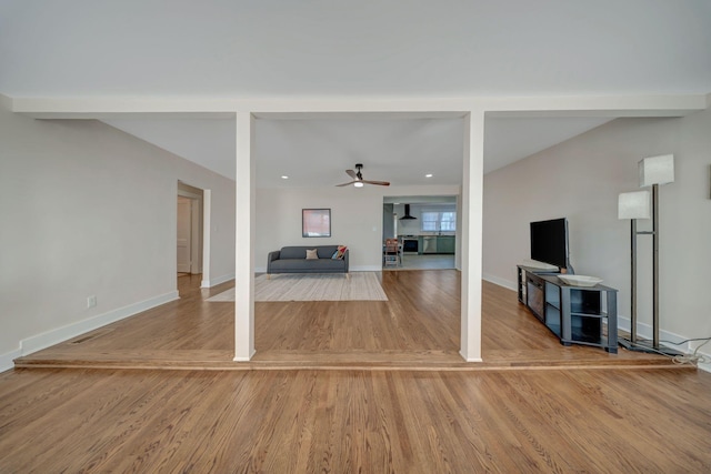 unfurnished living room featuring wood-type flooring and ceiling fan