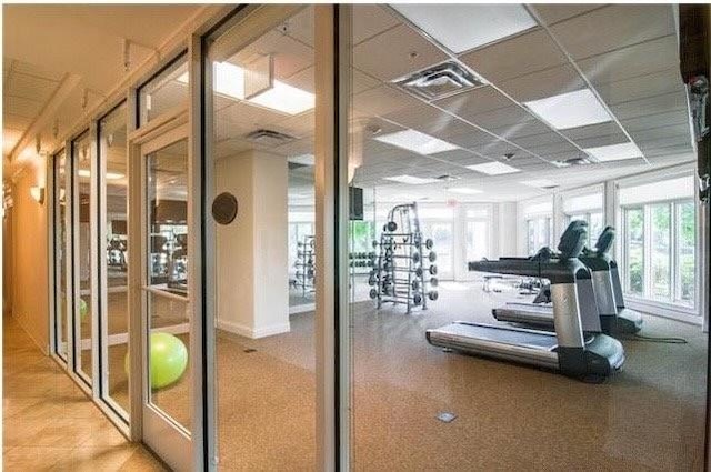 workout area featuring a drop ceiling