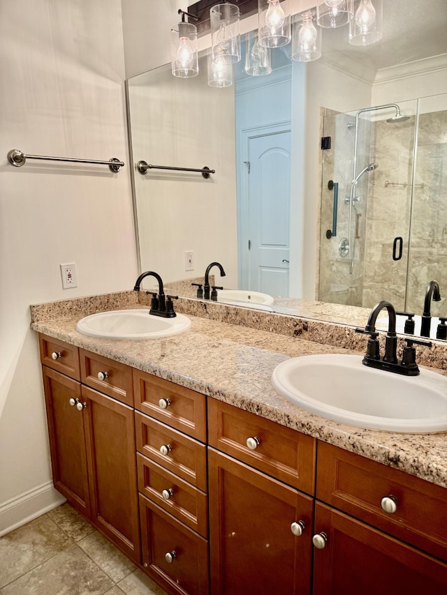 bathroom featuring a shower with door, vanity, tile patterned floors, and crown molding