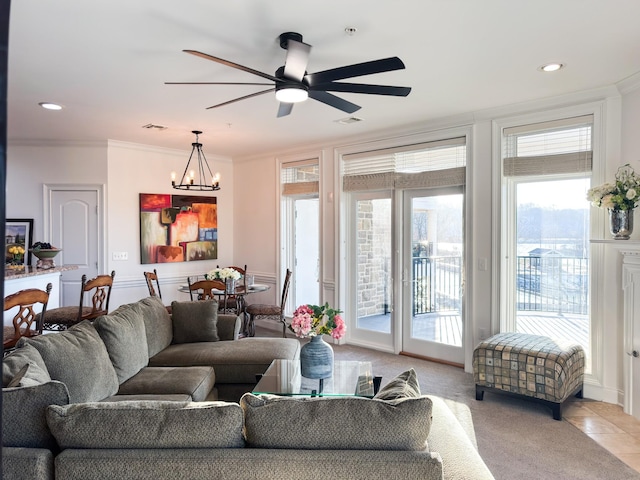 400 Warioto Way Unit 206, Ashland City, TN 37015 - living room featuring ceiling fan with notable chandelier, light carpet, crown molding, and visible vents