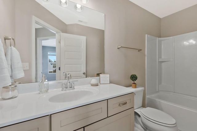 full bathroom featuring washtub / shower combination, vanity, and toilet