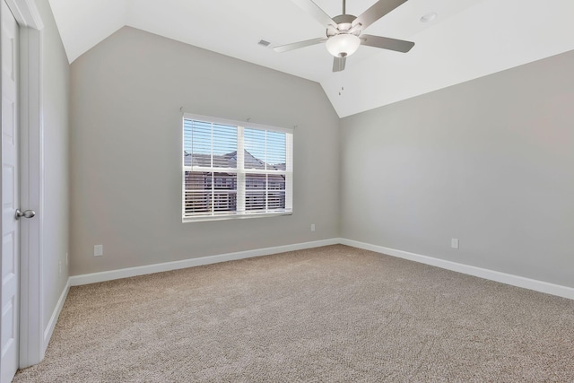 empty room with ceiling fan, lofted ceiling, and carpet floors