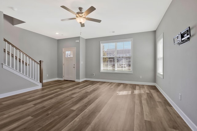 unfurnished living room featuring hardwood / wood-style flooring and ceiling fan