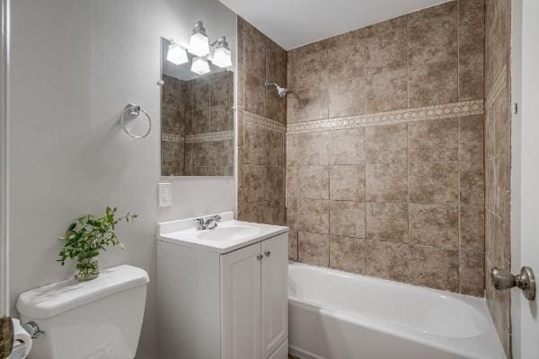 full bathroom featuring vanity, toilet, and tiled shower / bath