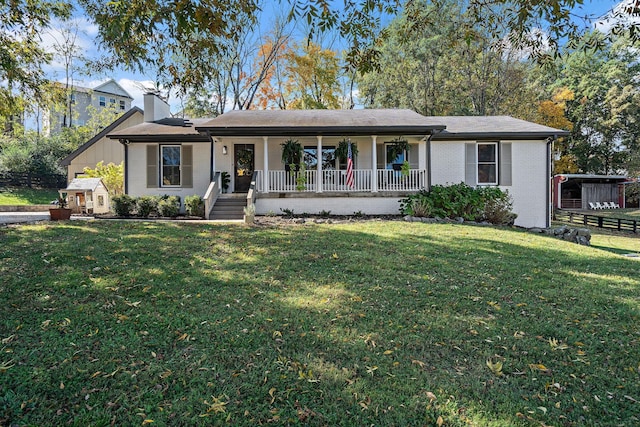 ranch-style home featuring a front lawn and covered porch