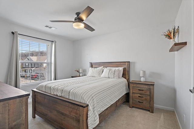 bedroom with ceiling fan and light carpet