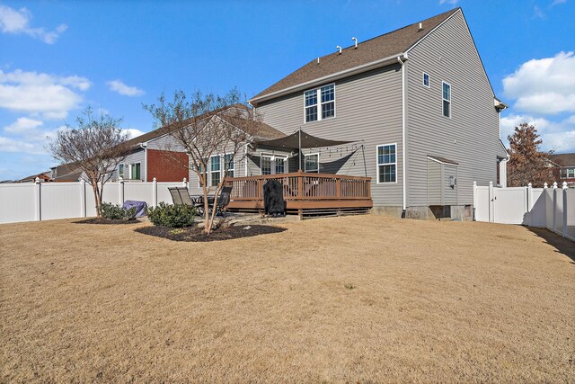 back of house featuring a deck and a yard