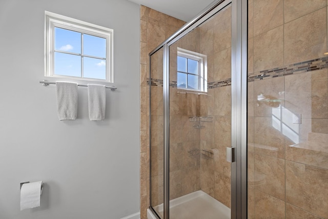 bathroom with walk in shower and plenty of natural light