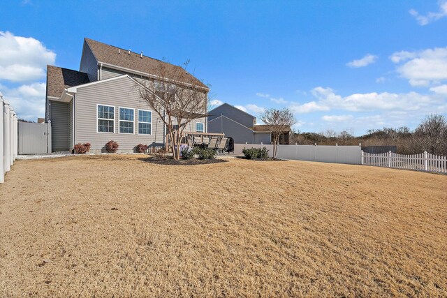 rear view of property with a lawn