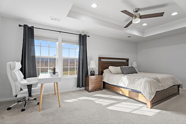 carpeted bedroom featuring ceiling fan, a raised ceiling, and ornamental molding