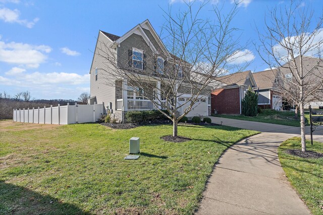 view of front of home with a front yard and a garage