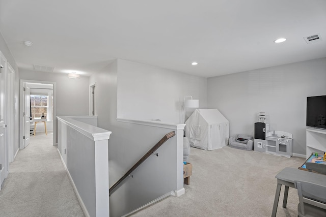 corridor with light colored carpet