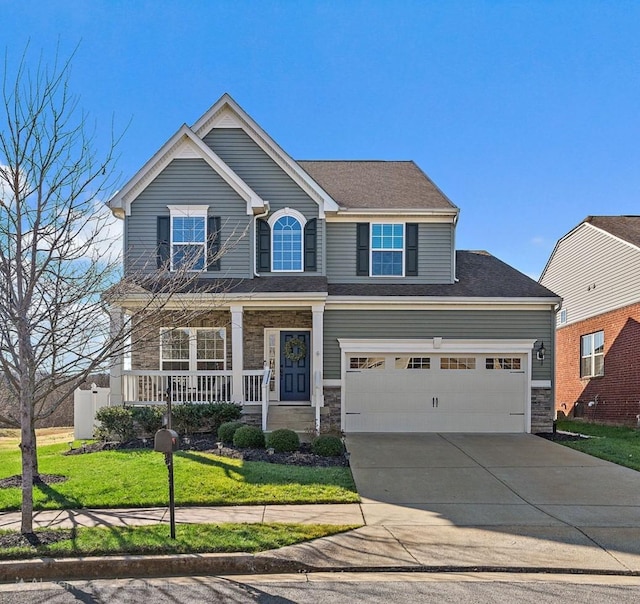 craftsman-style home with covered porch, a front yard, and a garage