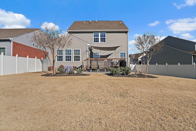 rear view of property with a lawn and a wooden deck