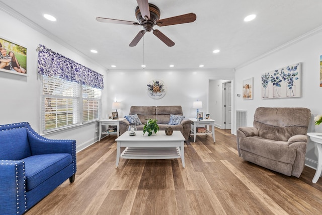 living room with ceiling fan, light wood-type flooring, and ornamental molding