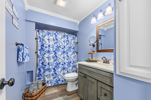 bathroom with wood-type flooring, vanity, toilet, and crown molding