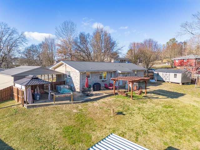 rear view of property with a gazebo, a pergola, a storage unit, and a lawn