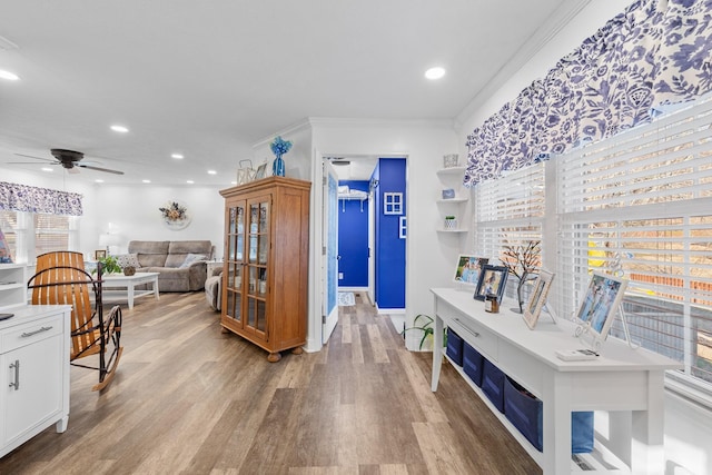 corridor with hardwood / wood-style floors and crown molding