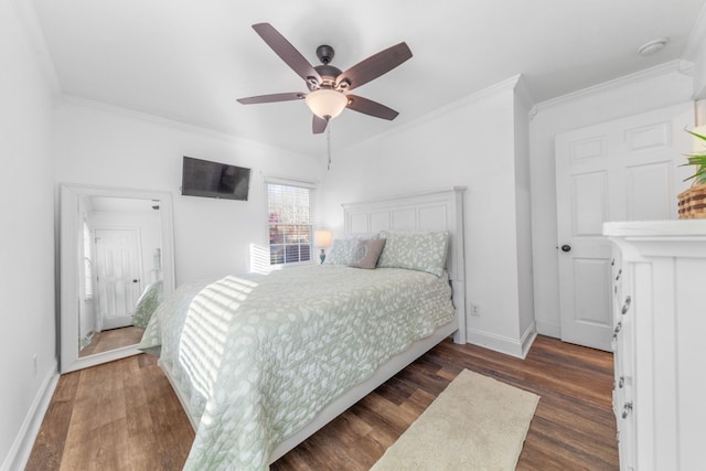 bedroom featuring dark hardwood / wood-style floors, ceiling fan, and ornamental molding