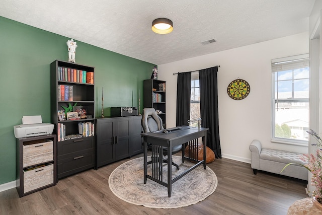 office space featuring a textured ceiling and hardwood / wood-style flooring