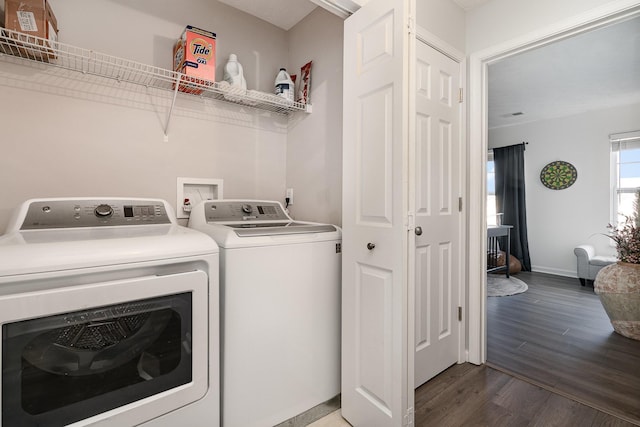 laundry area with dark wood-type flooring and washing machine and clothes dryer