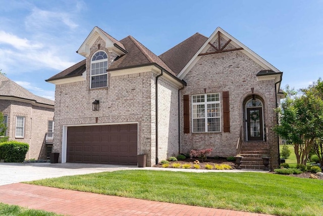 french country home featuring a front lawn and a garage