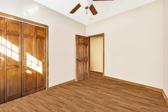 unfurnished bedroom featuring a closet, ceiling fan, and hardwood / wood-style flooring