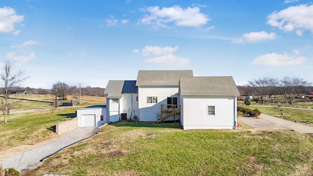 view of side of home with a lawn and a garage