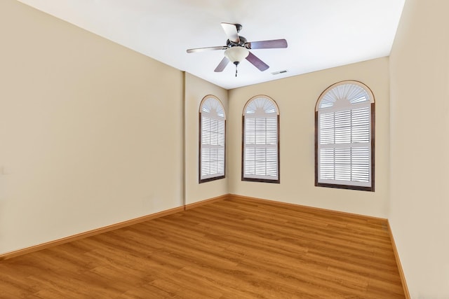 spare room with ceiling fan and wood-type flooring