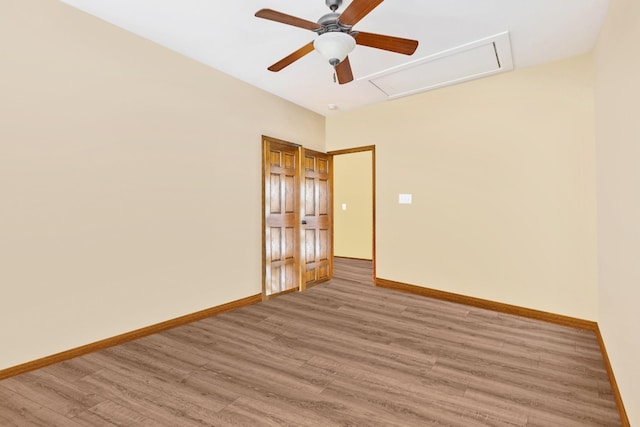 spare room with hardwood / wood-style flooring and ceiling fan