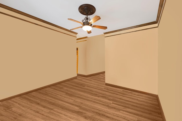 spare room featuring light hardwood / wood-style flooring and ornamental molding