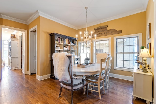 dining space with crown molding, dark wood-type flooring, and an inviting chandelier