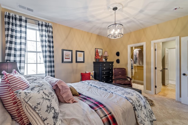 carpeted bedroom featuring multiple windows, a spacious closet, a closet, and an inviting chandelier