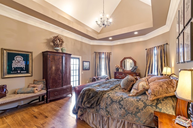 bedroom with wood-type flooring, a chandelier, high vaulted ceiling, ornamental molding, and a raised ceiling