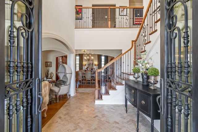 entrance foyer featuring a notable chandelier and a towering ceiling