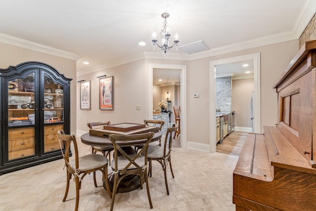 dining space featuring a notable chandelier and crown molding