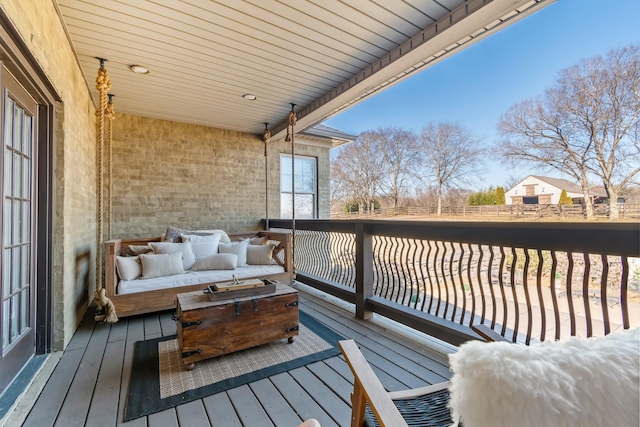 wooden terrace with an outdoor hangout area