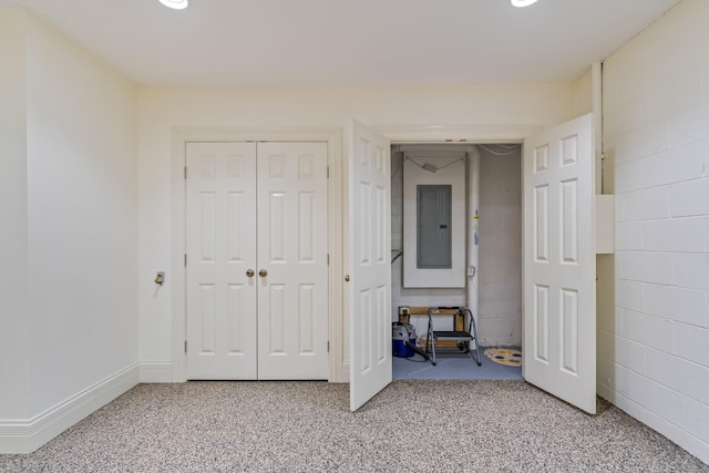 unfurnished bedroom featuring electric panel and carpet