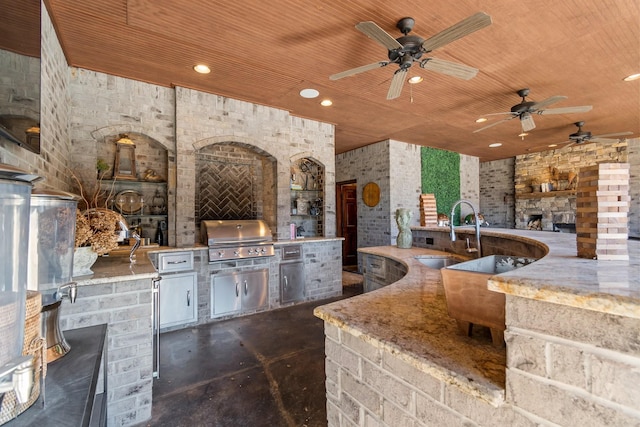 view of patio / terrace featuring an outdoor kitchen, sink, ceiling fan, a grill, and an outdoor stone fireplace