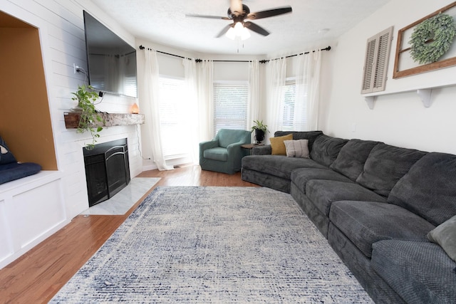 living room with ceiling fan and light hardwood / wood-style floors