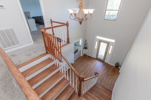 foyer entrance featuring dark wood-type flooring and an inviting chandelier