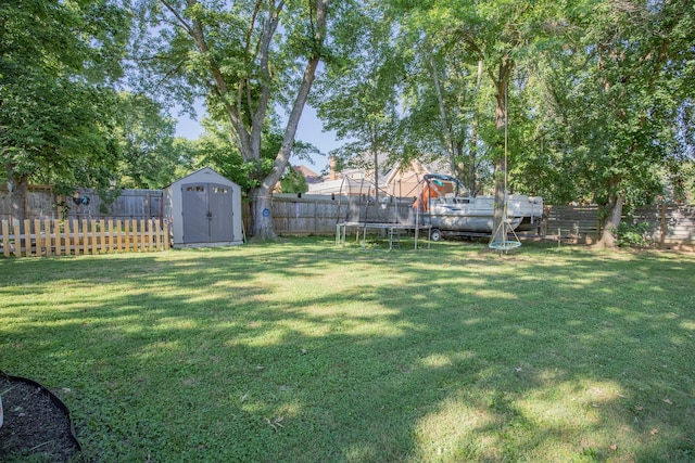 view of yard with a shed and a trampoline