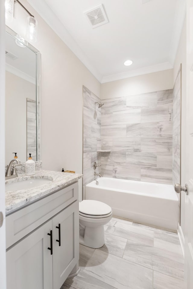 full bathroom featuring vanity, ornamental molding, tiled shower / bath combo, and toilet