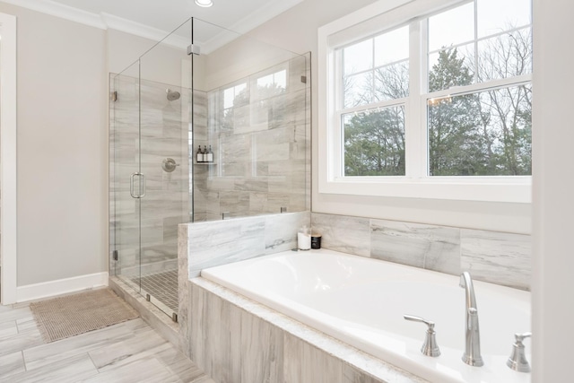 bathroom with ornamental molding, shower with separate bathtub, and a healthy amount of sunlight