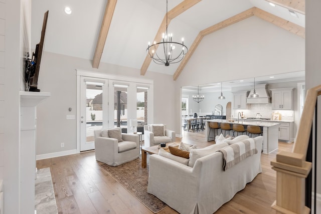 living room featuring high vaulted ceiling, an inviting chandelier, french doors, light wood-type flooring, and beam ceiling