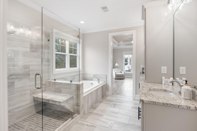 bathroom with ornamental molding, vanity, independent shower and bath, and a healthy amount of sunlight