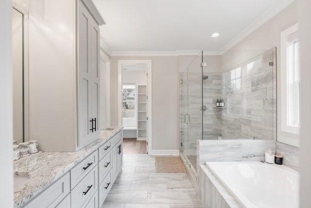 bathroom with separate shower and tub, crown molding, and vanity