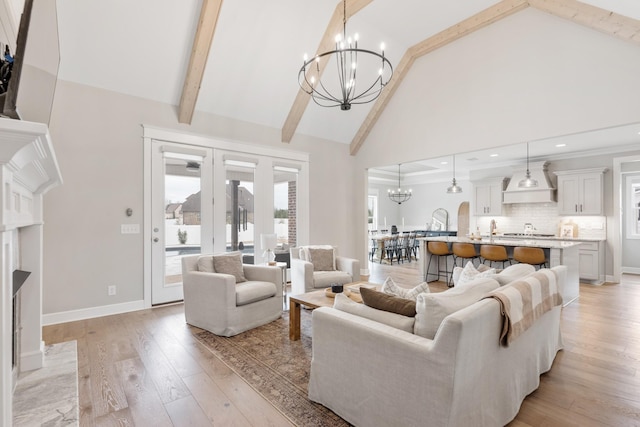 living room featuring light hardwood / wood-style floors, beam ceiling, high vaulted ceiling, and a chandelier