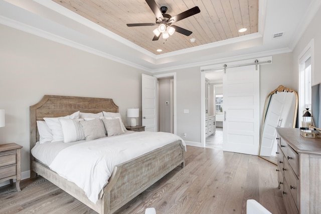 bedroom featuring a barn door, a tray ceiling, ceiling fan, and wooden ceiling