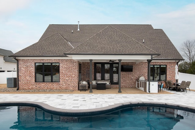 rear view of house featuring ceiling fan, a patio area, an outdoor hangout area, and central air condition unit